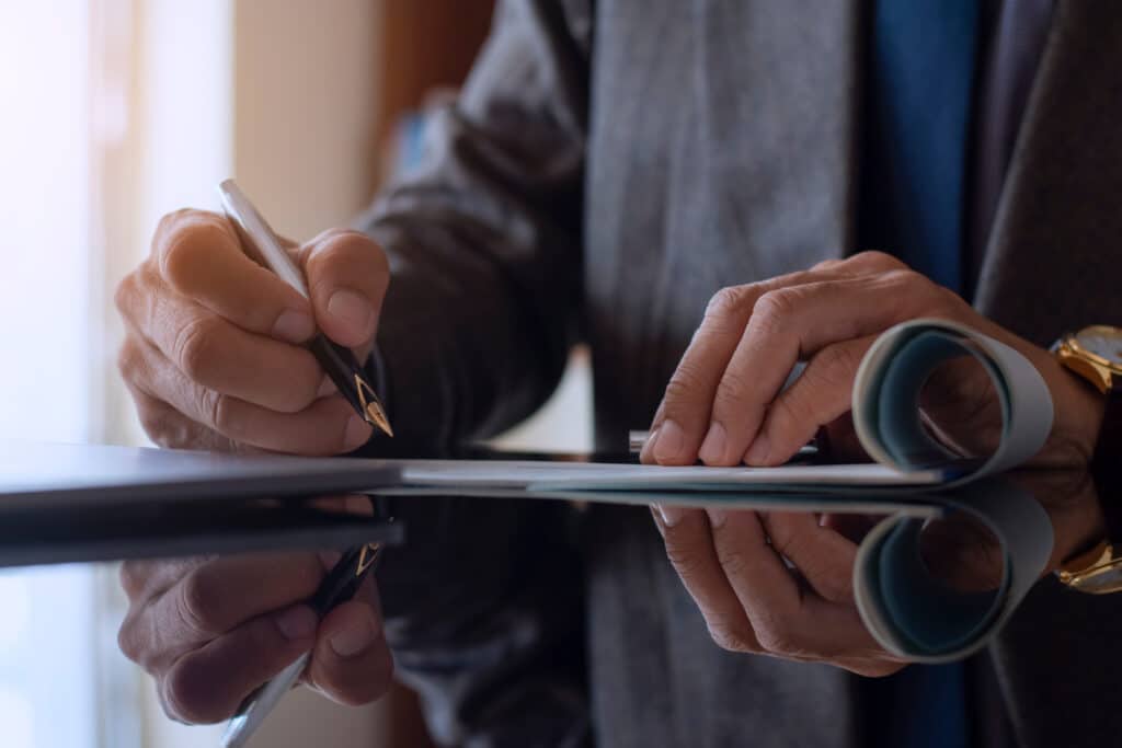 Man signing documents as desk